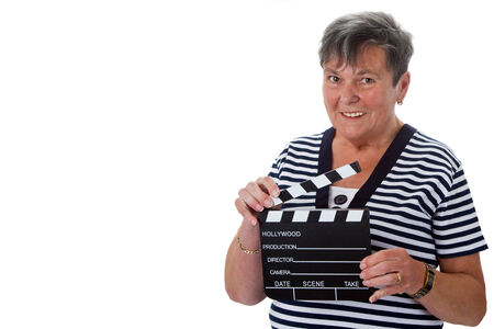 Senior woman with clapper board - isolatedの写真素材