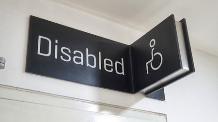 A prominently displayed 'Disabled' sign on a wall, emphasizing inclusivity and accessibility for all individualsの写真素材
