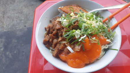 Savor the flavors of a delicious white bowl filled with a wholesome combination of succulent meat and vibrant vegetables. A nutritious culinary delightの写真素材