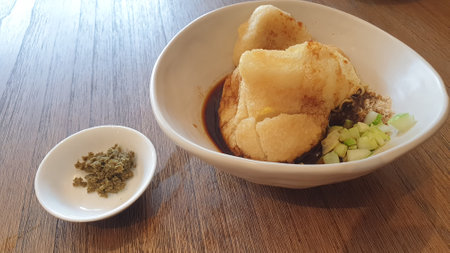 A delicious bowl of food on a beautifully set table, complete with a gleaming spoon, creating an inviting sceneの写真素材