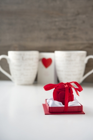 Valentine gift box with greeting card and two cups on wooden background  Close-upの写真素材