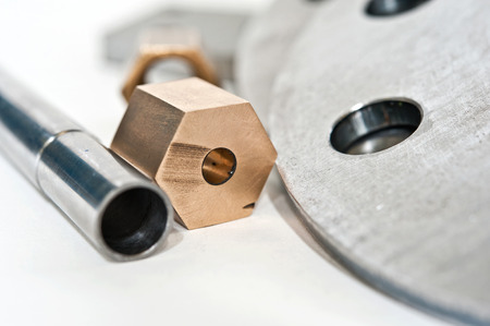 Metal flange pipe and brass nut. Milling and lathe industry. CNC technology.の写真素材