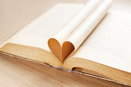 Heart shape from opened book pages. Indoors close-up.の写真素材