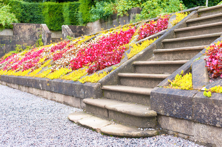 Old stone stairs in Glasgow country Pollok Park blossoming garden. Summertime outdoors.