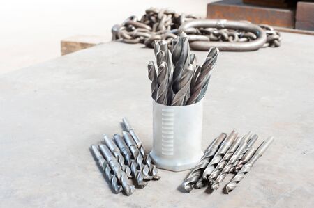 Many metal drill bits. Drilling and milling industry. Closeup.