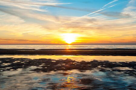 Multicolored summertime sunset on Baltic sea beach. Vibrant horizontal outdoors image