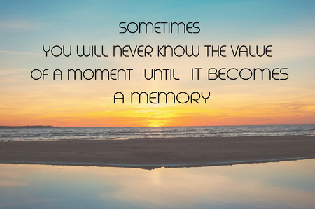 Sometimes you never know the value of a moment until it becomes a memory. Inspirational motivation quote on spectacular summertime sunset beach with blue sky background. Horizontal outdoors imageの写真素材