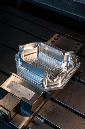 Industrial steel mold/ blank milling. Metalworking and mechanical engineering. CNC technology. Closeup vertical image.の写真素材