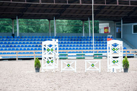 Image of show jumping poles on empty training field. Wooden barriers for horses as a background. Colorful photo of equestrian obstacles. Empty field for event competition. Horizontalの写真素材