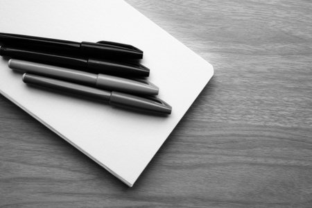 stationery and notebook on table B W