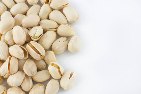 Close up of fresh pistachios on white