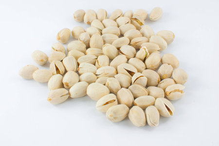 Close up of fresh pistachios on whiteの写真素材