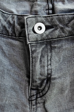 The crotch of grey jeans with a button and a line of zipの写真素材