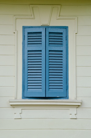 A classic blue window with the beige wall taken from the grand palace, Bangkokの写真素材
