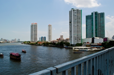 Chaopraya river with some ships and skyscrapersの写真素材