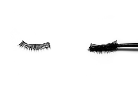 a mascara brush on artificial eyelashes on the white backgroundの写真素材