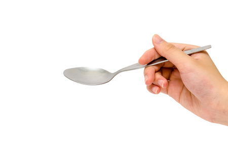a hand holding a spoonの写真素材