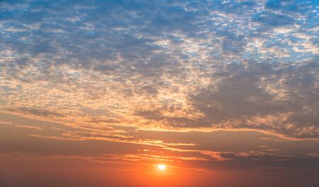the orange and blue sky when the sun is settingの写真素材