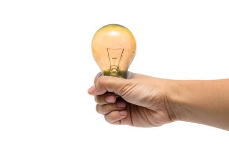a hand holding a yellow lightbulbの写真素材