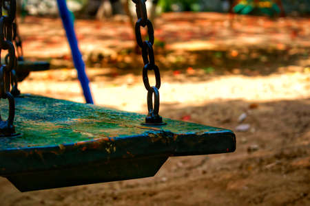 Chain swing with wooden seat in parkの写真素材