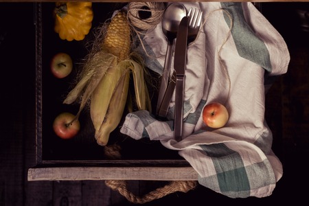 Pumpkins, apples, corn on a rustic table