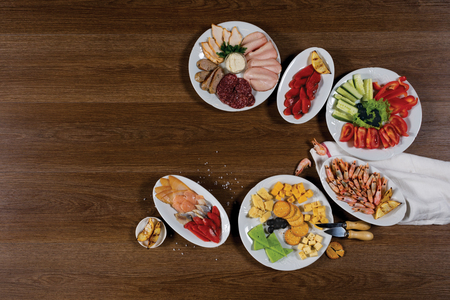 Wooden board with snacks for text or advertの写真素材