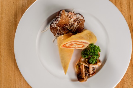 Meatloaf on a white plate on a wooden table closeupの写真素材