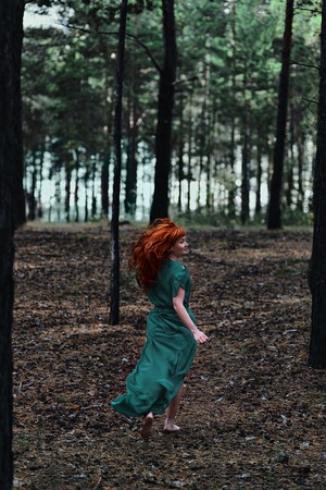 Red-haired girl in the woods. Fantasy conceptの写真素材