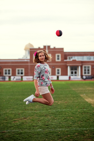 Beautiful girl on stadium with a ballの写真素材