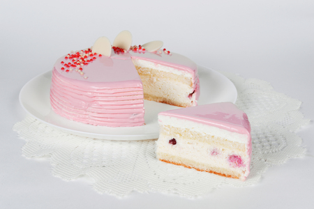 Celebratory cake on white shot close-up on whiteの写真素材