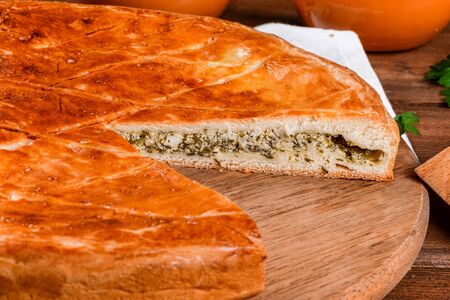 Home pie on a wooden table is shot close-up in the decorの写真素材