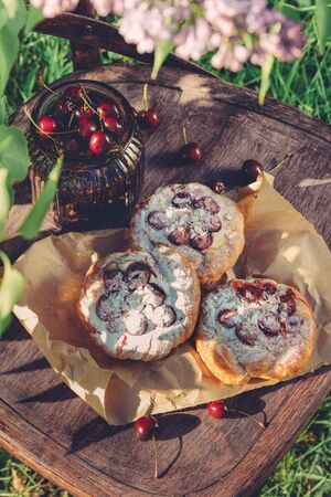 Cake with cherry in the decor is filmed in the gardenの写真素材