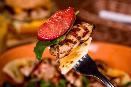 On the fork meat tomato greens shot close-upの写真素材