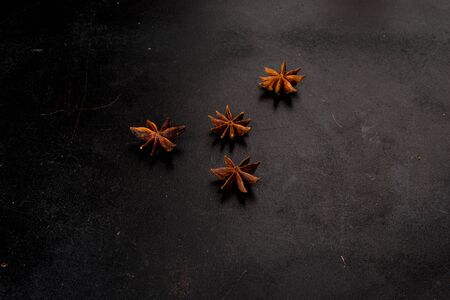Anise stars shot on a black backgroundの写真素材