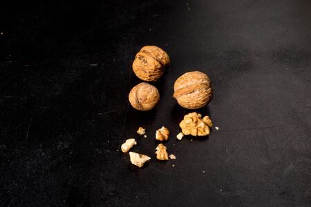 A few walnuts shot on a black background close-up