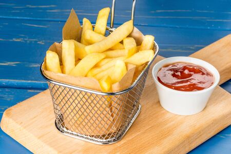 Traditional French fries with ketchup. Close-up shot