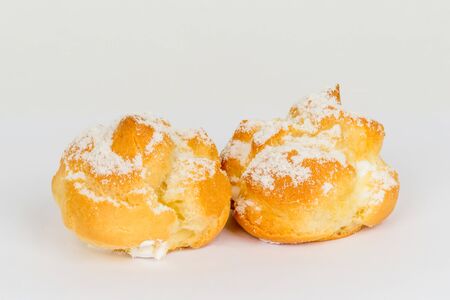 Two custard cakes shot on a white background under tenderloin. Close-up shot