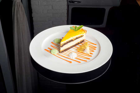 One slice of fruit cheesecake on a white plateの写真素材