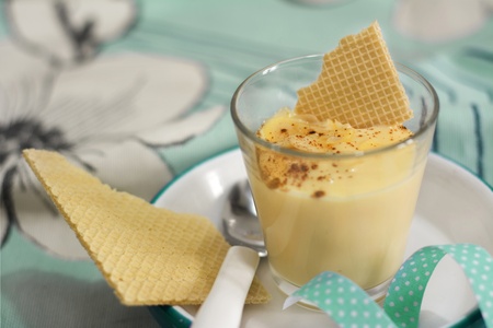 Crystal glasses with homemade vanilla ice cream and sliced ââalmonds, tablecloth with flower background, blue detailsの写真素材