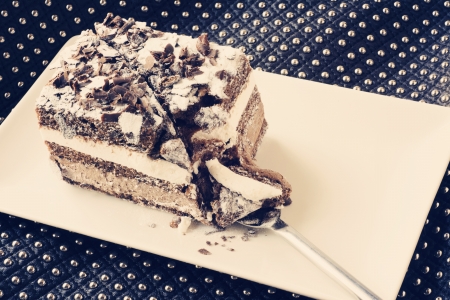 chocolate cake. musse filled with chocolate and whipped cream on square plate and white flowers
の写真素材