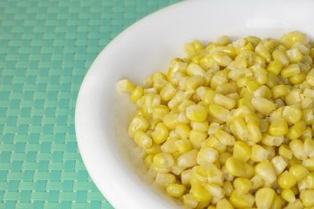 bowl with corn beans on blue tableclothの写真素材