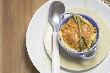 casserole, Italian filled pasta with tomato asparagus and peas on wooden backgroundの写真素材