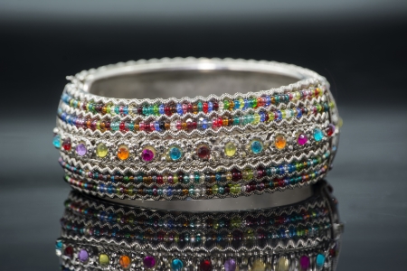 spiral bracelet of colored stones, transparent, on dark backgroundの写真素材
