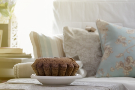 cake on the table in the living room , sofa and cushions background. quiet and modern environmentの写真素材