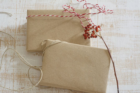 gift box wrapped in recycled paper, with ribbon bow,  with ribbon rustic, red and white の写真素材