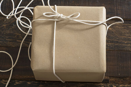 gift box wrapped in recycled paper, with ribbon bow,  with ribbon rustic の写真素材