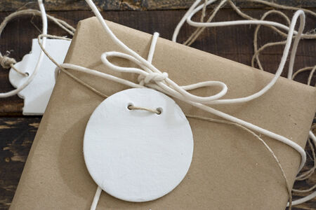 gift box wrapped in recycled paper, with ribbon bow,  with ribbon rustic, red and white の写真素材