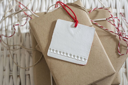 gift box wrapped in recycled paper, with ribbon bow,  with ribbon rustic, red and white の写真素材