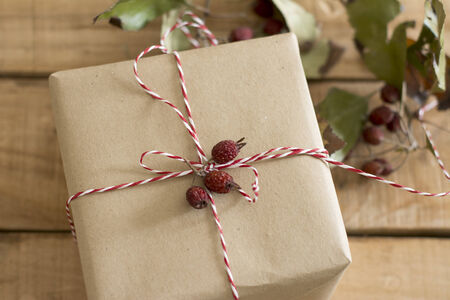 gift box wrapped in recycled paper, with ribbon bow,  with ribbon rustic, red and white の写真素材