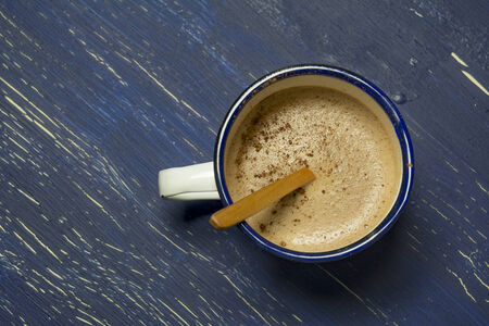 Hot chocolate in white metal cup on rustic background.  intense blue の写真素材